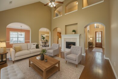 Relax in the spacious great room with arched doorw
