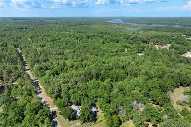 Birds eye view of property with a water view and a