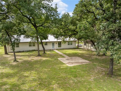 View of green lawn featuring an outdoor structure