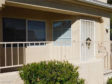 View of home's exterior with stucco siding and a b