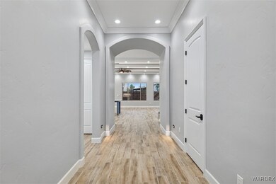 Hallway featuring light wood-type flooring and orn