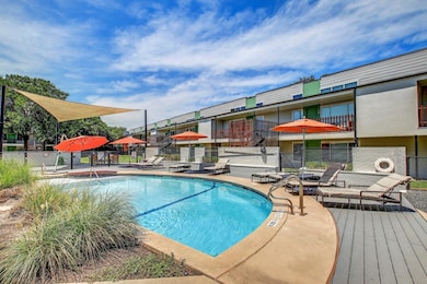 Community pool with fence and a patio area