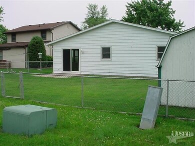 Fenced yard with shed & gate.