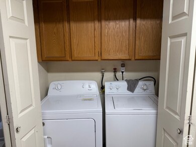 Laundry room featuring cabinet space and washer and clothes dryer