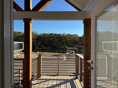 Deck with a water view and view of wooded area