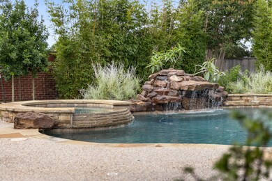 Pebble tech finish with pool heater, waterfall and spillway.