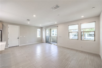 Empty room with recessed lighting and light wood f