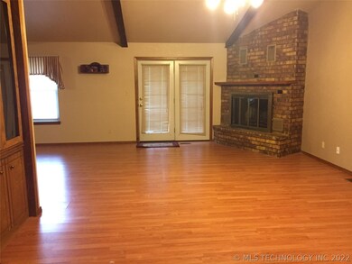 Entry to Living Room w/ Woodburning Fireplace.