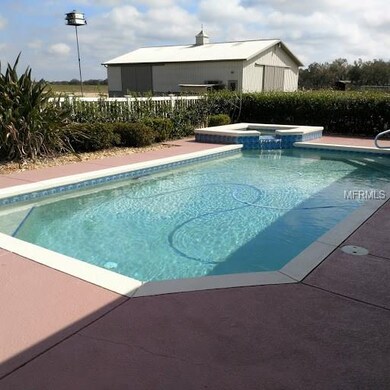 Hot tub has a waterfall feature flowing into the p