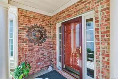 Covered Front Entrance: Glass storm door, sideligh