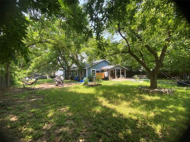 View of grassy yard featuring a patio area