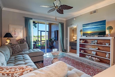 Living area featuring crown molding, a ceiling fan, and tile patterned floors