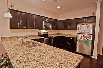 Loads of cabinets in this very roomy kitchen. Granite and stainless steel appliances.