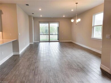 Spare room featuring a chandelier, dark wood-type 