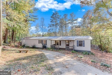 Manufactured / mobile home featuring covered porch and a metal roof