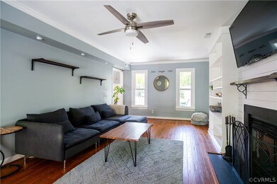 Living room with ornamental molding, wood flooring