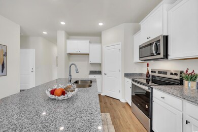 Kitchen with light stone countertops, light wood-s