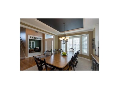 Dining room has bay window with plantation shutter
