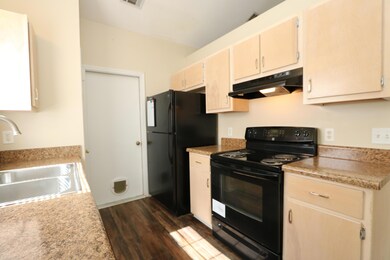 Kitchen with view of refrigerator