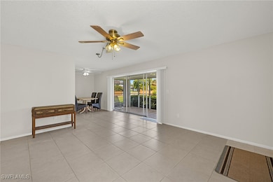 Spare room with ceiling fan, baseboards, a texture