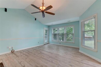 Great room with bright natural light and steps away from your private deck facing the woods