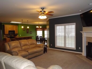 Great room opens to the kitchen with access door to covered back porch.