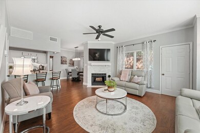 Living room featuring ceiling fan, a fireplace.