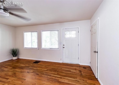 featuring wood finished floors, healthy amount of natural light, and ceiling fan
