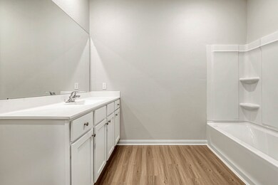 The en-suite primary bathroom has a shower/tub com