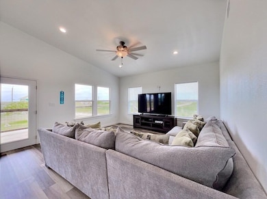 Living area with vaulted ceiling, recessed lighti