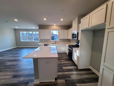 Fairfax Kitchen shown with white cabinets and quartz countertops.  Photo is of actual home.
