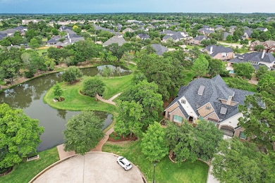 No neighbor on the left!  Quiet wooded neighborhood park and pond is located adjacent to the home and can be viewed from the grand dining room's floor to ceiling windows on the left side of the home.