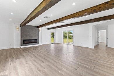 Unfurnished living room featuring light hardwood /