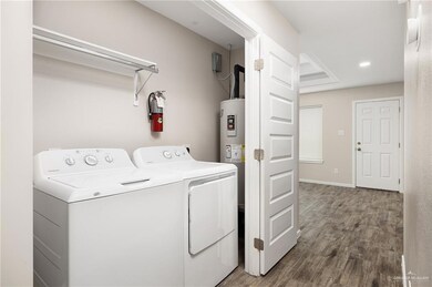 Laundry area featuring washing machine and clothes dryer and wood finished floors