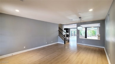 Spare room featuring stairs, visible vents, basebo