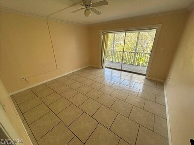 Spare room featuring crown molding, light tile pat