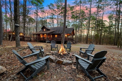 Yard at dusk featuring a fire pit and a wooden dec