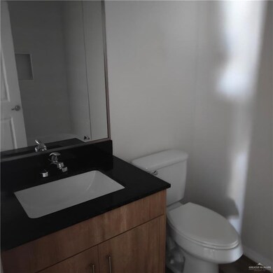 Half bath featuring vanity and toilet