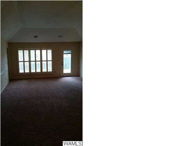 The den in this home is large with a tray ceiling,