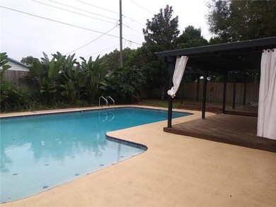 Pool surrounded by landscaping and decks.