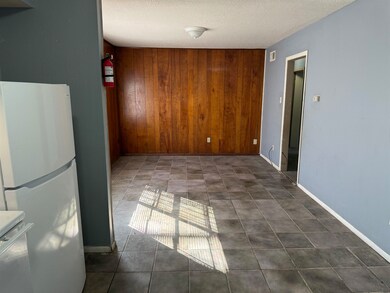 Interior space featuring a textured ceiling, range