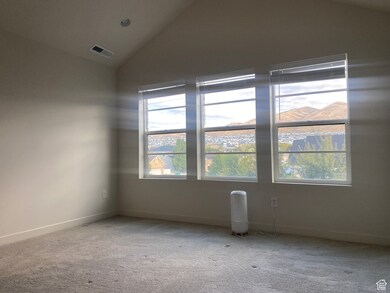 master bedroom featuring vaulted ceiling and carpet flooring