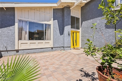 Property entrance featuring stucco siding