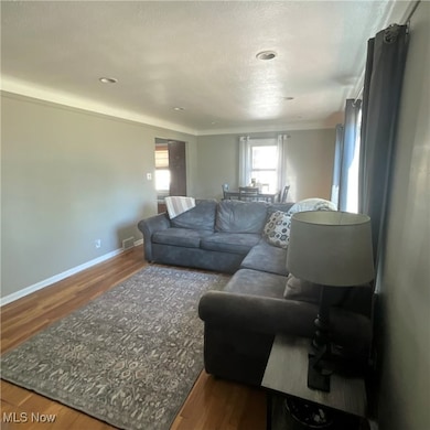 Living room with wood finished floors and a textured ceiling