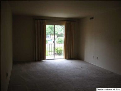 VIEW OF THE LIVING ROOM OUT TO THE BALCONY
