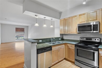 Kitchen with sink, light wood-type flooring, appli