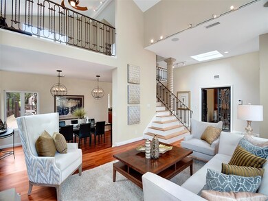 Elegant living room is flooded with light and feat