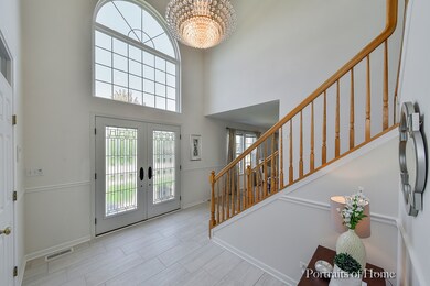 Two-story entrance foyer with modern tile througho