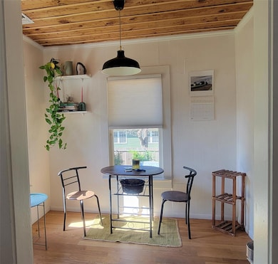 Dining area featuring wood ceiling, crown molding