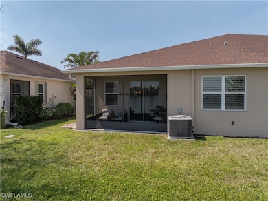 Rear view of house featuring stucco siding, centra